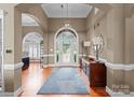 Elegant foyer with hardwood floors, high ceilings, designer lighting, and an arched doorway at 7412 Sahalee Dr, Denver, NC 28037