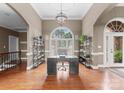 Bright home office with a large window, hardwood floors, and custom shelving at 7412 Sahalee Dr, Denver, NC 28037