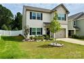 Attractive two-story home featuring black shutters, a well-maintained lawn, and tasteful landscaping at 750 Fraternity Row, Kannapolis, NC 28081