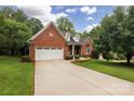 Charming brick home with a well-manicured lawn and a spacious driveway, ideal for suburban living at 8008 Alba Ct, Charlotte, NC 28269