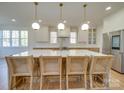 Modern kitchen boasts a large island with seating, pendant lighting, and stainless steel appliances at 8039 Mcconnell Rd, Denver, NC 28037