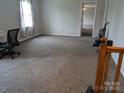 Large bedroom with neutral carpet, light walls, and an open doorway at 936 New Camp Creek Church Rd # 11, Kings Mountain, NC 28086