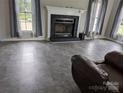 Open living room space with fireplace and gray tile flooring at 936 New Camp Creek Church Rd # 11, Kings Mountain, NC 28086