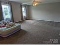 Spacious main bedroom with natural light and neutral carpeting at 936 New Camp Creek Church Rd # 11, Kings Mountain, NC 28086
