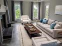 Bright living room with modern furniture, fireplace, and views from windows at 936 New Camp Creek Church Rd, Kings Mountain, NC 28086