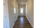 Bright entryway with wood-look flooring leading to a white framed glass panel front door at 108 Red Juniper Way, Statesville, NC 28625