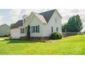 Well-maintained home with vinyl siding, lush green lawn, and vibrant landscaping on a sunny day at 1083 Elljoy Ln, Salisbury, NC 28146