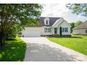Charming single-Gathering home featuring a manicured lawn, long driveway, and attached two-car garage at 1083 Elljoy Ln, Salisbury, NC 28146