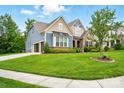 Lovely home with a well-kept lawn, a side-entry two-car garage, and a welcoming entrance at 10903 Skymont Dr, Huntersville, NC 28078