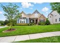 Charming home with lush green lawn, mature trees, and a welcoming front facade at 10903 Skymont Dr, Huntersville, NC 28078