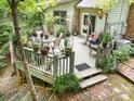 Charming outdoor back deck featuring attractive furniture and views of lush green landscaping at 1102 Lake Montonia Rd, Kings Mountain, NC 28086