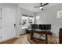 Bright home office with large windows, hardwood floors, and a ceiling fan at 1124 Greenbridge Dr, Matthews, NC 28105