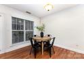 Well lit dining area featuring hardwood floors, natural lighting, and modern table with four chairs at 1136 W 1St St, Charlotte, NC 28202
