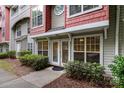 The exterior features a covered entrance, well-maintained landscaping and neutral siding with a touch of red brick at 1136 W 1St St, Charlotte, NC 28202