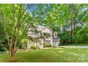 Traditional two-story home nestled among mature trees with a long driveway at 116 Oak Creek Dr, Charlotte, NC 28270