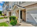 Up-close view of townhouse entrance with manicured plants at 117 Langhorne Dr, Mount Holly, NC 28120