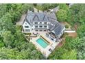 Aerial view of a two-story home featuring a backyard pool and lush landscaping at 11710 Ney Manor Way, Charlotte, NC 28277