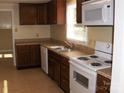 Traditional kitchen featuring wood cabinets, white appliances and tiled flooring for easy maintenance at 134 Crystal Cir, Mooresville, NC 28117