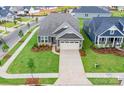 Aerial view of a single-Gathering home with neutral siding, manicured lawn and a two car garage at 1818 Winding Mist Dr, Belmont, NC 28012