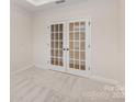 Well-lit home office features double doors, plush carpet and overhead lighting at 1818 Winding Mist Dr, Belmont, NC 28012