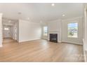 Bright living room showcases a cozy fireplace and expansive hardwood floors at 1818 Winding Mist Dr, Belmont, NC 28012