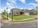 Street view of a single-Gathering home with neutral siding, a well-kept lawn and a two car garage at 1818 Winding Mist Dr, Belmont, NC 28012