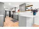 Modern kitchen featuring gray cabinets, stainless steel appliances, and light wood floor at 201 Forest Rd, Taylorsville, NC 28681