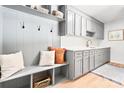 Well-organized mudroom with built-in storage, bench, and gray cabinetry with a sink at 201 Forest Rd, Taylorsville, NC 28681