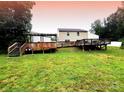 Expansive backyard featuring a multi-tiered wooden deck, perfect for outdoor entertaining and relaxation at 2021 Tarzi Ln, Charlotte, NC 28215