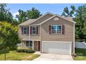 Charming two-story home with a two-car garage, red shutters, and a well-manicured lawn under a clear blue sky at 2021 Tarzi Ln, Charlotte, NC 28215