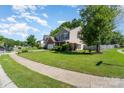 Landscaped lawn showcases a charming two-story home with lush greenery and a sidewalk at 2206 Waters Trail Dr, Charlotte, NC 28216