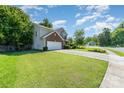 Two-story home with a brick accent, green shutters, and manicured lawn on a beautiful street at 2206 Waters Trail Dr, Charlotte, NC 28216