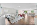Open-concept living area featuring a cozy couch, stylish chairs, and seamless flow to the dining area at 2217 Goldwood Dr, Charlotte, NC 28215