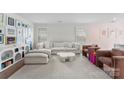 Bright living room with a comfortable white couch, stylish decor, and natural light from the windows at 2217 Goldwood Dr, Charlotte, NC 28215