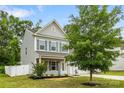 Charming two-story home with gray siding, a well-manicured lawn, and a two-car garage at 3053 Riker St, Clover, SC 29710