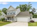 Charming two-story home with gray siding, a well-manicured lawn, and a two-car garage at 3053 Riker St, Clover, SC 29710