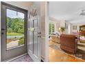 Inviting foyer with a view into the spacious living room featuring hardwood floors at 3225 Mill Pond Rd, Charlotte, NC 28226