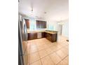 Spacious kitchen featuring stainless appliances, tile floors, and wood cabinets for a modern and clean feel at 3430 Fincher Blvd, Charlotte, NC 28269