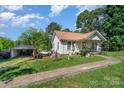 Traditional home featuring a detached garage, driveway, and mature trees at 4059 10Th Avenue Sw Dr, Hickory, NC 28602