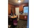 Functional kitchen with wood paneling, featuring ample counter space and essential appliances at 415 N Secrest Ave, Monroe, NC 28110