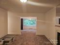 Open-concept living room with an adjacent dining room at 4520 Bradbury Dr, Charlotte, NC 28209