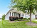 Attractive home featuring a covered front porch, green lawn and lush landscaping around the property at 505 Belle Grove Dr, Lake Wylie, SC 29710