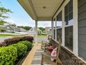 Inviting front porch with rocking chairs and a decorative rug, offering a relaxing outdoor space at 505 Belle Grove Dr, Lake Wylie, SC 29710