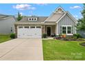 Charming home with a well-manicured lawn and a two-car garage, showcased on a sunny day at 5079 Skyfest Dr, Charlotte, NC 28215