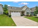 Charming home with a well-manicured lawn and a two-car garage, showcased on a sunny day at 5079 Skyfest Dr, Charlotte, NC 28215
