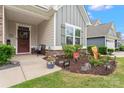 Cozy front porch with inviting decor and landscaping, welcoming guests to this lovely home at 5079 Skyfest Dr, Charlotte, NC 28215