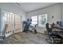Versatile office space with modern floors, natural light, and a doorway leading to other parts of the house at 5125 Thomasville Dr, Belmont, NC 28012