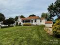 Well-maintained home on a large, grassy lot, featuring a quaint shed and mature trees at 522 W Congress St, Lincolnton, NC 28092