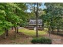 Secluded home surrounded by mature trees, featuring a well-manicured lawn and inviting front porch at 5317 Black Oak Ln # 11, Waxhaw, NC 28173