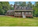 Traditional two-story home with a cozy front porch, set on a lush green lawn under a clear sky at 5317 Black Oak Ln # 11, Waxhaw, NC 28173